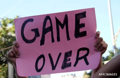 Palestinian protesters wear Guy Fawkes masks as they hold an effigy of Palestinian Prime Minister Salam Fayyad during a protest against the high cost of living, in the West Bank city of Hebron September 4, 2012. The Arab...