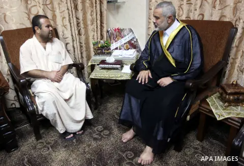 Ismail Haniya, the head of the Hamas government in the Gaza Strip, receives the family of the martyr Ihab Abu Nada in Gaza City on September 5, 2012. The death of a young Gaza man who set himself on fire because he could...