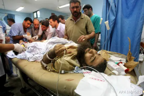A wounded Palestinian man receives treatment at the al-Aqsa hospital in Deir al-Balah, Gaza strip center, following an Israeli airstrike on September 5, 2012. Photo by Ashraf Amra