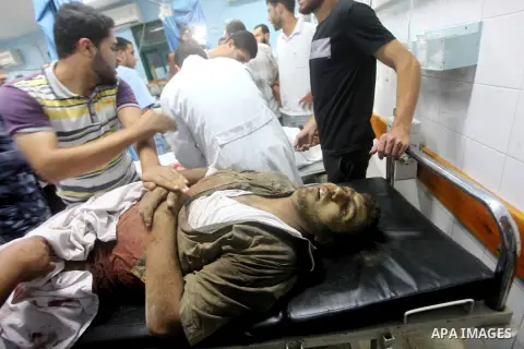 Palestinians gesture next to bodies of gunmen at a hospital in central Gaza Strip September 5, 2012. An Israeli air strike on the Hamas-governed Gaza Strip killed three gunmen as they tried to launch short-range rockets...