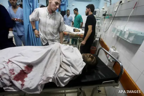 Palestinians gesture next to bodies of gunmen at a hospital in central Gaza Strip September 5, 2012. An Israeli air strike on the Hamas-governed Gaza Strip killed three gunmen as they tried to launch short-range rockets...