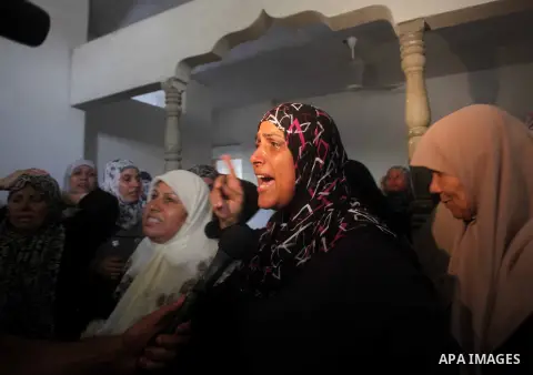 Relatives of Palestinian Tareq al-Kafarna mourn during his funeral in Beit Hanun in the northern Gaza Strip on September 6, 2012. Three Palestinians were killed by Israeli fire in the northern Gaza Strip, raising to six...