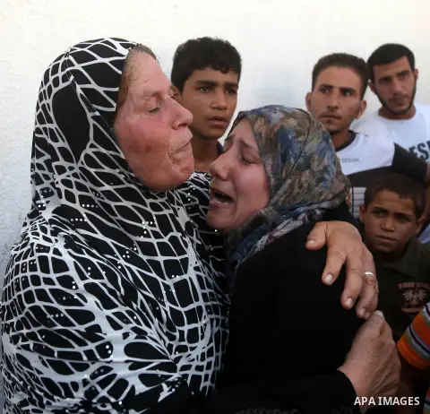 Palestinian relatives of Ihab and Akram al-Zaanin, two brothers who were killed by Israeli fire in the northern Gaza Strip, mourn their death on September 6, 2012. Three Palestinians were killed by Israeli fire in the no...
