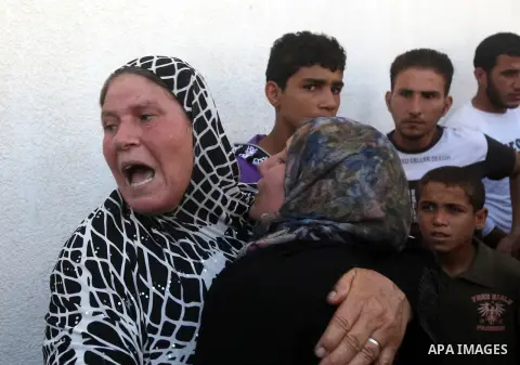 Palestinian relatives of Ihab and Akram al-Zaanin, two brothers who were killed by Israeli fire in the northern Gaza Strip, mourn their death on September 6, 2012. Three Palestinians were killed by Israeli fire in the no...