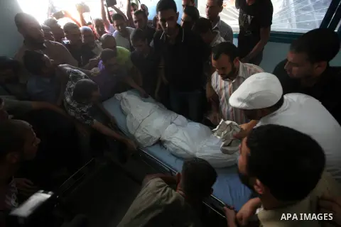 Palestinian mourners carry the body of Tareq al-Kafarna mourn during his funeral in Beit Hanun in the northern Gaza Strip on September 6, 2012. Three Palestinians were killed by Israeli fire in the northern Gaza Strip, r...
