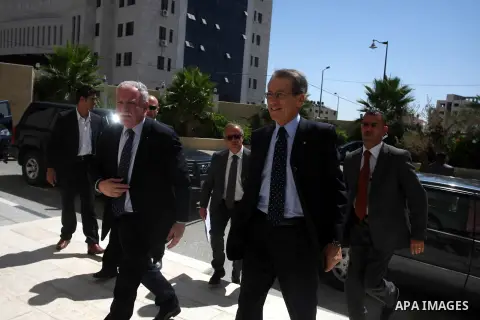 Palestinian Foreign Minister Riyad el Malki (front L) and his Italian counterpart Giulio Terzi (front R) enter the office of Palestinian Prime Minister Salam Fayyad before a meeting in the West Bank city of Ramallah Sept...