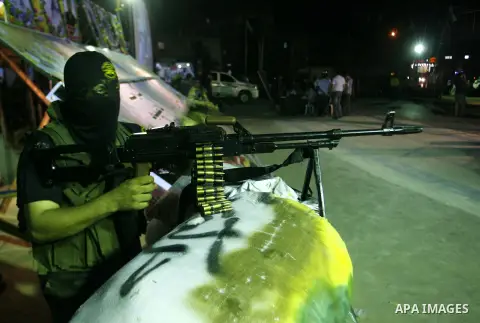 Militants from the Al-Quds Brigades march on patrol in a street in Rafah, southern Gaza strip, on September 6, 2012. An Israeli air strike on the Hamas-governed Gaza Strip killed three gunmen, one of them Al-Geram, as th...
