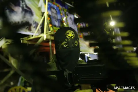 Militants from the Al-Quds Brigades march on patrol in a street in Rafah, southern Gaza strip, on September 6, 2012. An Israeli air strike on the Hamas-governed Gaza Strip killed three gunmen, one of them Al-Geram, as th...