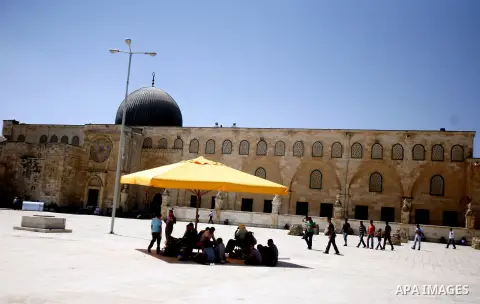 Palestinians walk in front of the Dome of Rock mosque during Friday prayers, in the Al Aqsa Mosque compound, in Jerusalem's old city on Sep. 07, 2012. Photo by Mahfouz Abu Turk