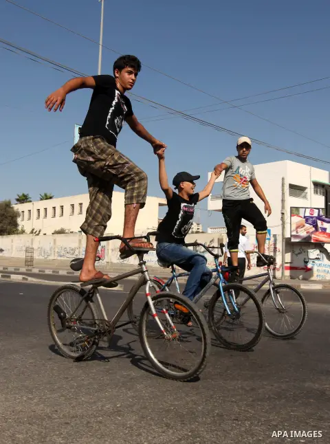 Palestinian youth ride a bicycle on a street in Gaza City, on Sep. 07, 2012. Photo by Majdi Fathi