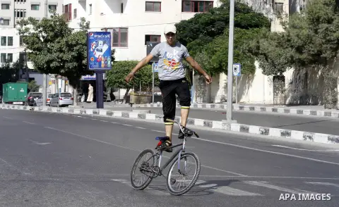 Palestinian youth ride a bicycle on a street in Gaza City, on Sep. 07, 2012. Photo by Majdi Fathi