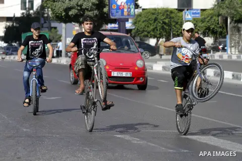 Palestinian youth ride a bicycle on a street in Gaza City, on Sep. 07, 2012. Photo by Majdi Fathi