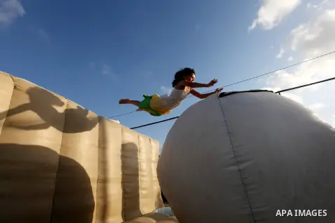 Palestinian children enjoy jump in an amusement Si Lamy park southern Gaza Strip on Sep. 07, 2012. Photo by Majdi Fathi