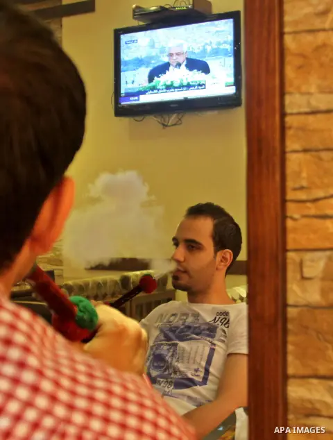 Palestinians watch TV as President Mahmoud Abbas (Abu Mazen), delivers speech to discusses the economic situation in the West Bank and Gaza strip, In a cafe in the West Bank city of Nablus on Sep. 08, 2012. Photo by Neda...