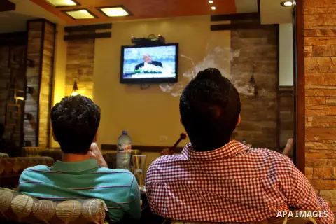Palestinians watch TV as President Mahmoud Abbas (Abu Mazen), delivers speech to discusses the economic situation in the West Bank and Gaza strip, In a cafe in the West Bank city of Nablus on Sep. 08, 2012. Photo by Neda...