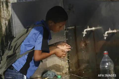 A Palestinian student drinks potable water at a water purification station, in Rafah refugee camp in the southern of Gaza Strip, on September 08. 2012. Photo by Eyad Al Baba