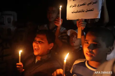 Palestinian children light candles during a rally in solidarity with prisoners in Israeli jails, in front of the Red Cross' offices in Gaza city, September 08, 2012. Photo by Majdi Fathi