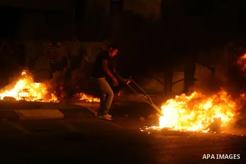 Palestinians youth burn tyres during a protest against the high cost of living at Al-Amari refugee camp in the West Bank city of Ramallah on September 8, 2012. Dozens of Palestinians burned tyres and blocked the road int...