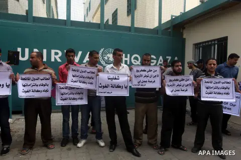 Palestinians take part in a protest against unemployment and the economic situation in the Gaza Strip, in front of the UNRWA headquarters in Gaza city on Sep. 09, 2012. Photo by Ashraf Amra