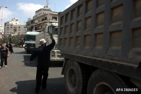 Palestinian truck drivers block a road during a protest against the high cost of living in the West Bank city of Ramallah, Sunday, Sep. 09, 2012. Photo by Issam Rimawi