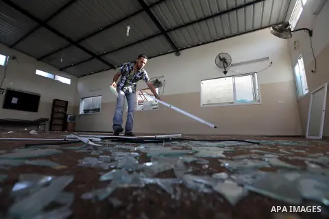 Palestinians inspect the damage at Mosque in Qassam training camp following an Israeli airstrike in Gaza City, early Tuesday, Sep. 10, 2012. Palestinian militants fired rockets towards Israel on Sunday. Photo by Majdi Fa...