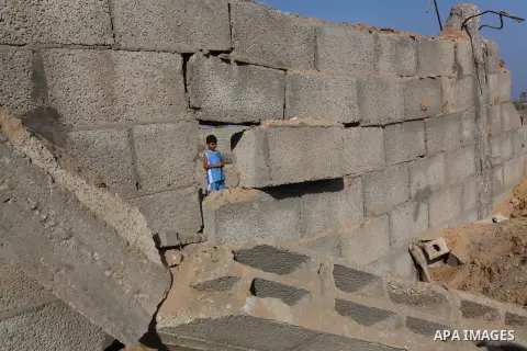 Palestinians inspect the damage to a building after an Israeli air strike in Nuseirat refugee camp in the central Gaza Strip September 10, 2012. An Israeli army statement said the Israeli air force targeted four sites in...