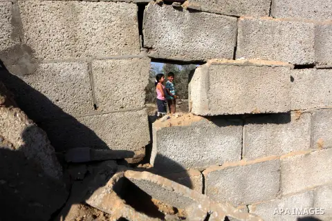 Palestinians inspect the damage to a building after an Israeli air strike in Nuseirat refugee camp in the central Gaza Strip September 10, 2012. An Israeli army statement said the Israeli air force targeted four sites in...
