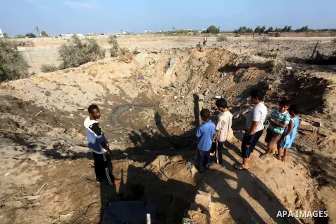 Palestinians inspect the damage to a building after an Israeli air strike in Nuseirat refugee camp in the central Gaza Strip September 10, 2012. An Israeli army statement said the Israeli air force targeted four sites in...