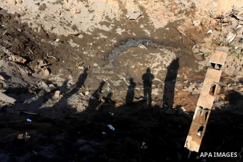 Palestinians inspect the damage to a building after an Israeli air strike in Nuseirat refugee camp in the central Gaza Strip September 10, 2012. An Israeli army statement said the Israeli air force targeted four sites in...
