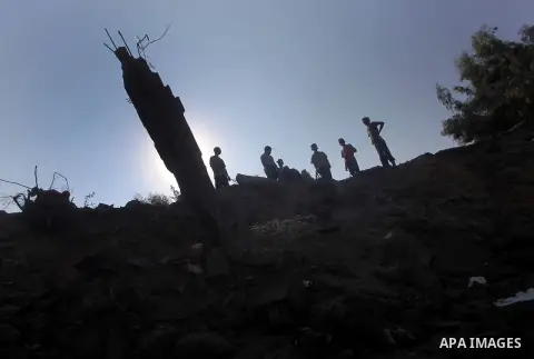 Palestinians inspect the damage to a building after an Israeli air strike in Nuseirat refugee camp in the central Gaza Strip September 10, 2012. An Israeli army statement said the Israeli air force targeted four sites in...