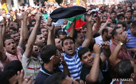 Palestinians chant slogans against Palestinian Prime Minister Salam Fayyad during a protest against the high cost of living in the West Bank city of Hebron, Monday, Sept. 10, 2012. Palestinian demonstrators fed up with h...