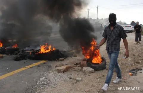 Palestinian youths close streets in Ramallah by burning tires during a protest against the high cost of living on September 10, 2012. Cities across the West Bank ground to a halt as transport unions called a mass general...