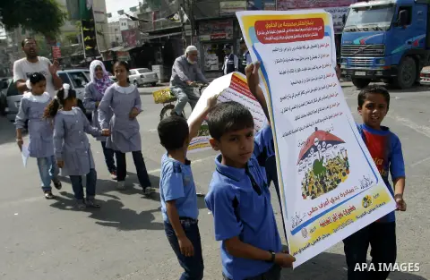 Palestinian students participate in a rally during a campaign to defend their rights in Rafah, in the southern Gaza Strip, Sep. 11, 2012. Photo by Eyad Al Baba
