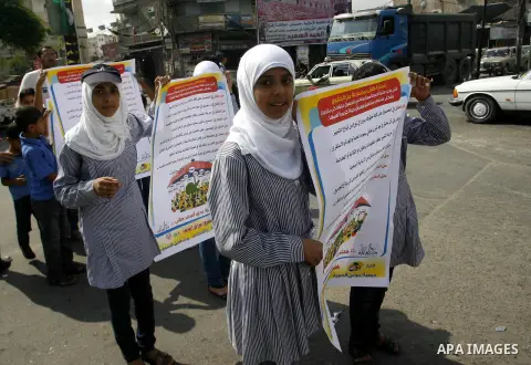 Palestinian students participate in a rally during a campaign to defend their rights in Rafah, in the southern Gaza Strip, Sep. 11, 2012. Photo by Eyad Al Baba