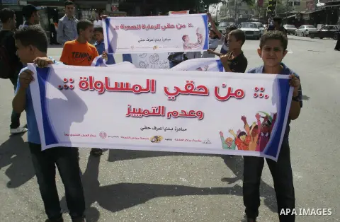 Palestinian students participate in a rally during a campaign to defend their rights in Rafah, in the southern Gaza Strip, Sep. 11, 2012. Photo by Eyad Al Baba
