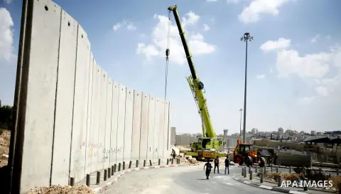 Israeli bulldozers work on the separation barrier in Shu'fat refugee camp in Jerusalem, September 11, 2012. Photo by Mahfouz Abu Turk