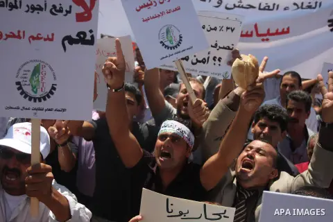 Palestinian protesters shout slogans during a demonstration against the high cost of living in the West Bank city of Ramallah, Sept. 11, 2012. The prime minister pledged on Tuesday that the Palestinian Authority will dec...