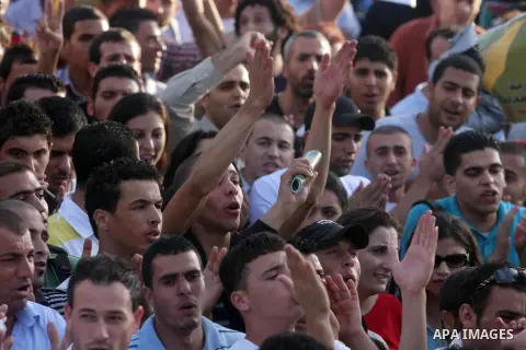 Palestinians shout slogans during a protest against the Paris Protocol and the Oslo Agreement, both key accords which govern economic ties between Palestinians and Israelis, in the West Bank city of Ramallah on September...