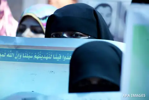 Palestinian women hold a placard depicting jailed relatives during a protest in Gaza City calling for the release of Palestinian prisoners from Israeli jails September 12 2012. Photo by Ashraf Amra