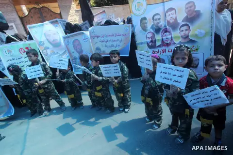 Palestinian children hold a placard depicting jailed relatives during a protest in Gaza City calling for the release of Palestinian prisoners from Israeli jails September 12 2012. Photo by Ashraf Amra