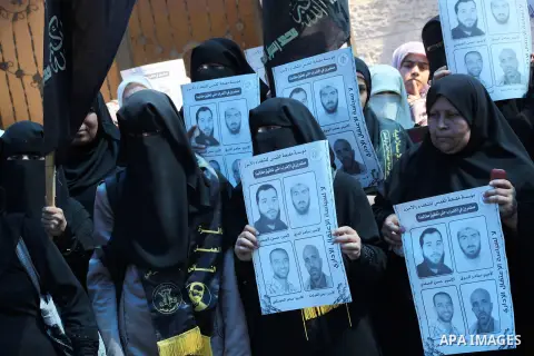 Palestinian women hold a placard depicting jailed relatives during a protest in Gaza City calling for the release of Palestinian prisoners from Israeli jails September 12 2012. Photo by Ashraf Amra