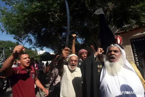 Palestinians hold swords and knifes during protest in front of the United Nations headquarters in Gaza city against the showing of a movie that is allegedly offensive to Muslim Prophet Mohammad, Sept 12, 2012. Photo by A...