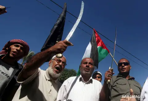 Palestinians hold swords and knifes during protest in front of the United Nations headquarters in Gaza city against the showing of a movie that is allegedly offensive to Muslim Prophet Mohammad, Sept 12, 2012. Photo by A...