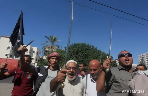 Palestinians hold swords and knifes during protest in front of the United Nations headquarters in Gaza city against the showing of a movie that is allegedly offensive to Muslim Prophet Mohammad, Sept 12, 2012. Photo by A...