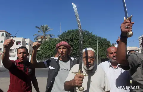 Palestinians hold swords and knifes during protest in front of the United Nations headquarters in Gaza city against the showing of a movie that is allegedly offensive to Muslim Prophet Mohammad, Sept 12, 2012. Photo by A...