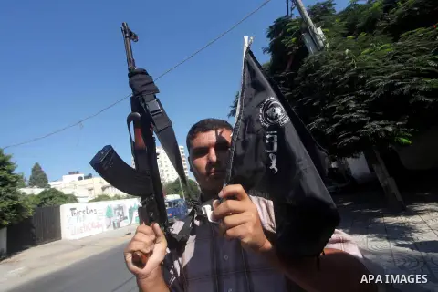 A Palestinian man hold AK47 weapon during protest in front of the United Nations headquarters in Gaza city against the showing of a movie that is allegedly offensive to Muslim Prophet Mohammad, Sept 12, 2012. Photo by As...
