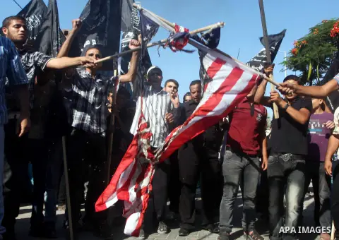 Palestinians burn the U.S. flag during a protest in front of the United Nations headquarters in Gaza city against the showing of a movie that is allegedly offensive to Muslim Prophet Mohammad, Sept 12, 2012. Photo by Ash...
