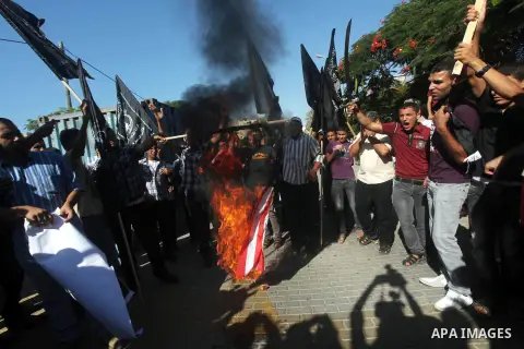 Palestinians burn the U.S. flag during a protest in front of the United Nations headquarters in Gaza city against the showing of a movie that is allegedly offensive to Muslim Prophet Mohammad, Sept 12, 2012. Photo by Ash...