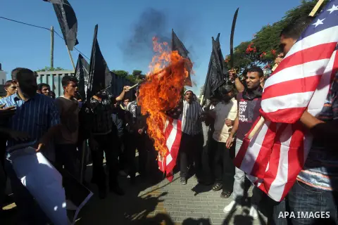 Palestinians burn the U.S. flag during a protest in front of the United Nations headquarters in Gaza city against the showing of a movie that is allegedly offensive to Muslim Prophet Mohammad, Sept 12, 2012. Photo by Ash...