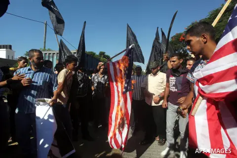 Palestinians burn the U.S. flag during a protest in front of the United Nations headquarters in Gaza city against the showing of a movie that is allegedly offensive to Muslim Prophet Mohammad, Sept 12, 2012. Photo by Ash...